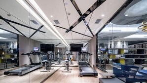 A modern gym with treadmills, ellipticals, and weight machines. - Orange Hotel (Hefei Huaihe Road Pedestrian Street Dadongmen Metro Station) (Hefei)