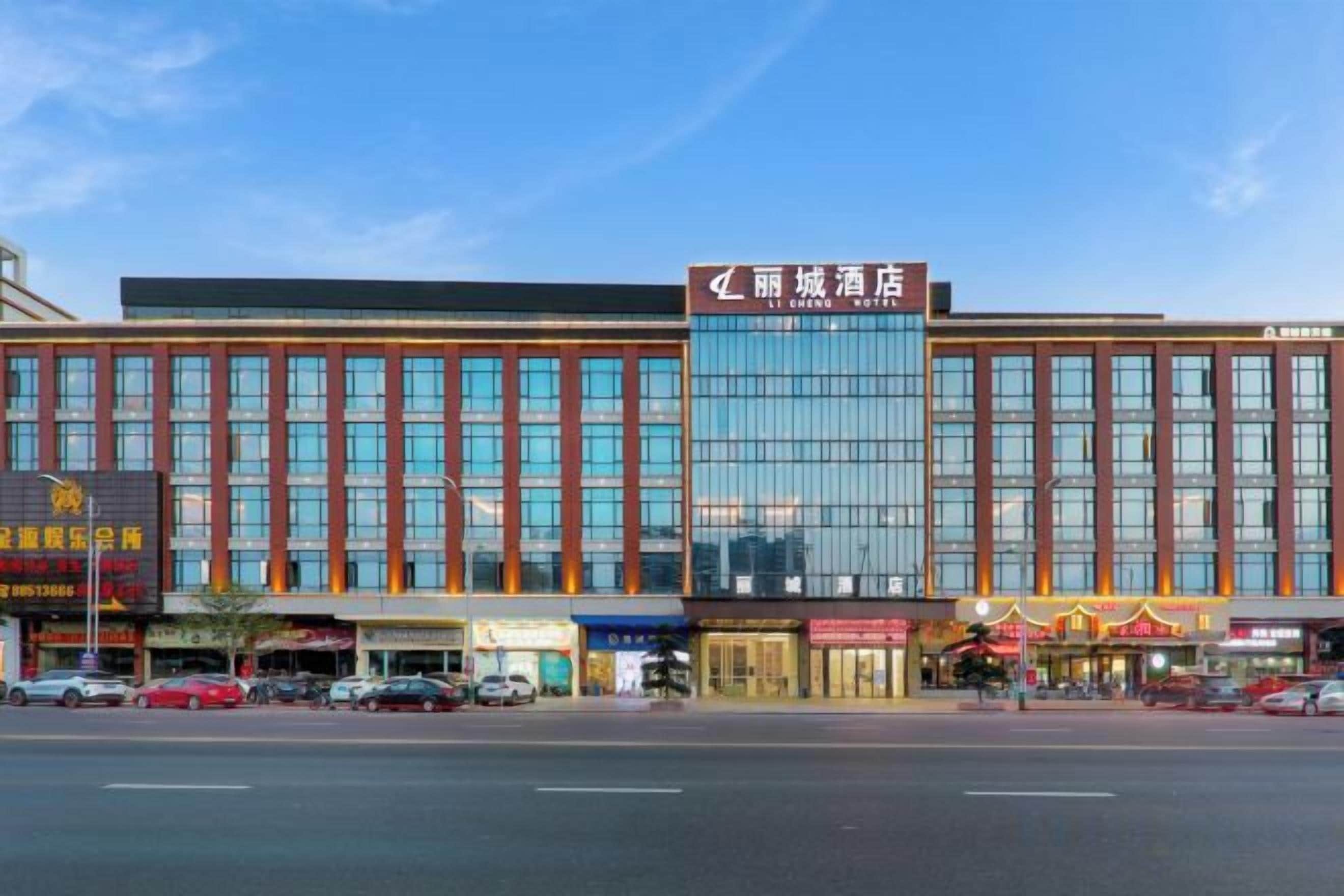 A multi-story hotel with a prominent entrance, large windows, and a clear sky above.