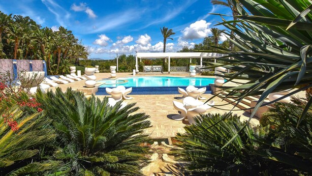 A pool area with lounge chairs, a covered seating area, and tropical plants. - Nice home in Partinico with WiFi (Partinico)