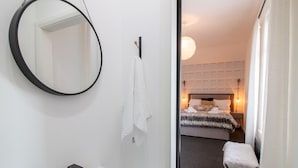 A bathroom with a sink, mirror, and towel rack. - Chic Beamish Retreat | Stylish 3-Bed Near Durham - Pass the Keys (Stanley)