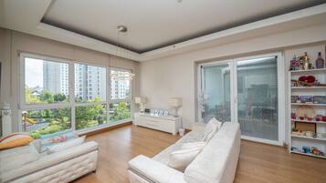 Deluxe-Apartment, Stadtblick | Wohnbereich | 126-Zoll-LED-Fernseher mit Digitalempfang