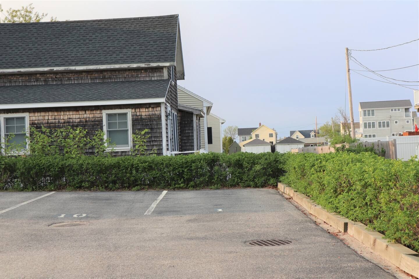 A parking lot with a building in the background.
