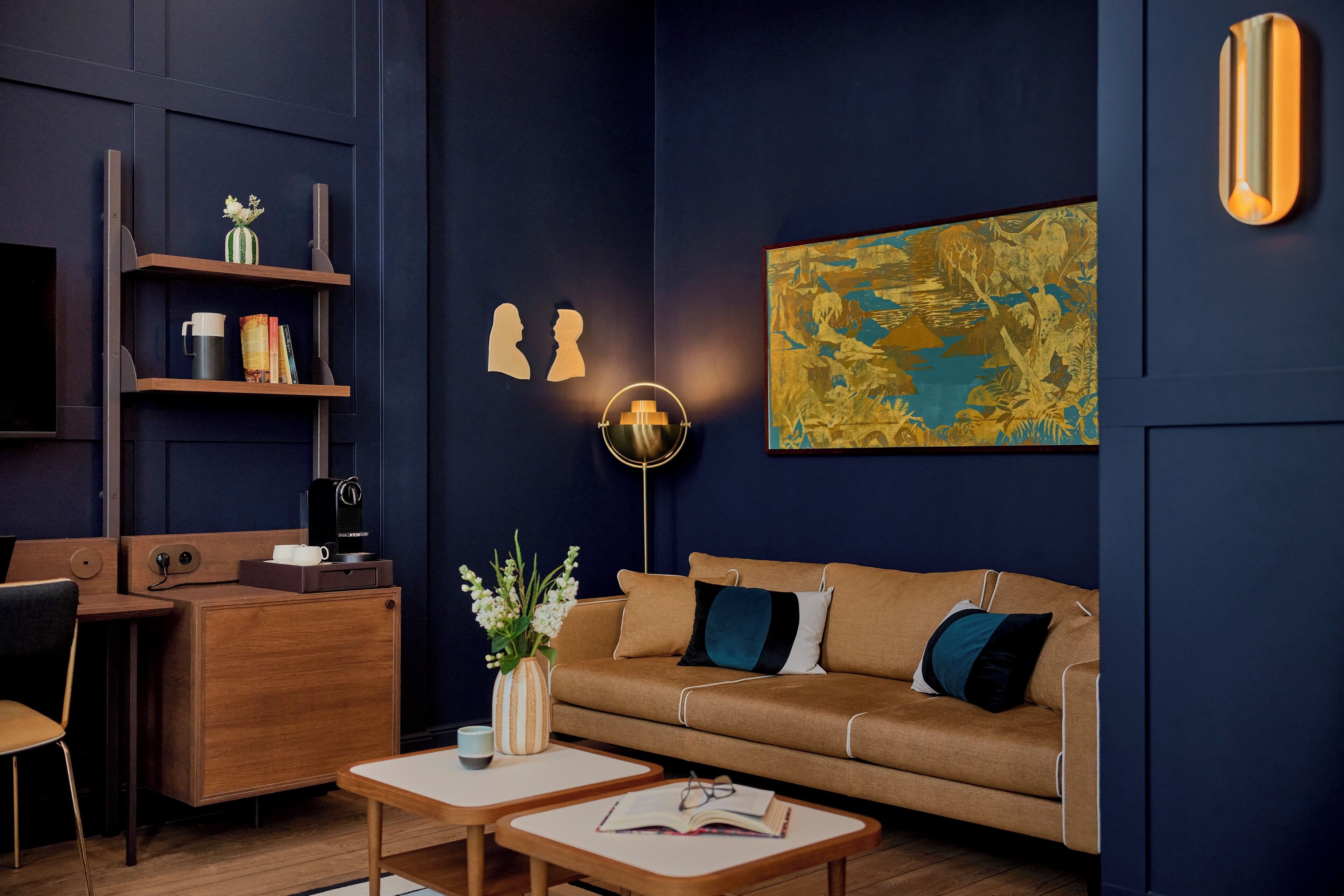 A modern living room with a sofa, coffee table, and a bookshelf.