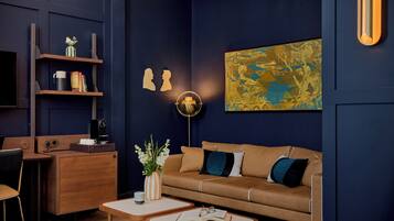 A modern living room with a sofa, coffee table, and a bookshelf.