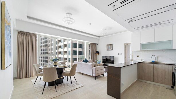 A modern apartment with a dining area, living room, and kitchen. - ME DO RE residence (Dubai)