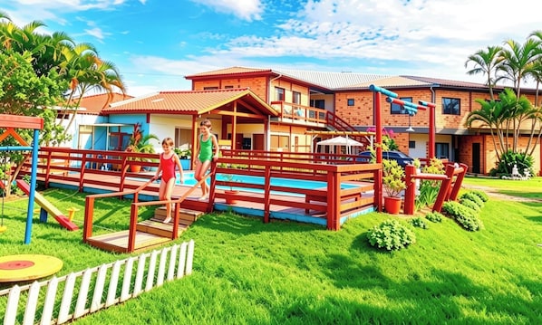 A playground with a pool, a fenced area, and a building with a red roof. - Pousada Aurema (Imbituba)