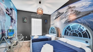 A Star Wars-themed room with two beds, a desk, and a large mural of space scenes. - Amazing and unique Dream House Experience just 5 Min to Disney Parks  (Kissimmee)