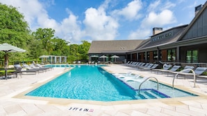 A rectangular swimming pool with a depth marker of 3 ft 6 in, surrounded by lounge chairs and umbrellas. - Tropical Retreat: Luxe 2BR/2BA with Pool & Gym (Jacksonville)