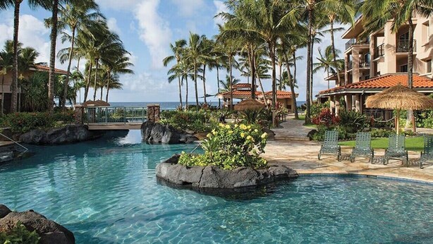A resort pool with clear water, palm trees, and a view of the ocean. - OceanView Marriott Waiohai beach club 2BDRM villa , Full Resort Access  (Koloa)