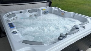 A hot tub with multiple jets, a control panel, and a QR code sticker. - National Forest, Fishing, Trail riding, Hunting, Bars/Eatery and Pet-Friendly (Gilman)