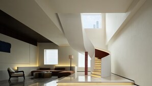 A modern interior with a staircase, seating area, and large windows. - Book'in Hotel (Changsha)