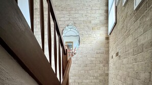 A staircase with wooden railings and a brick wall. - Little Gem in the City (Braddon)