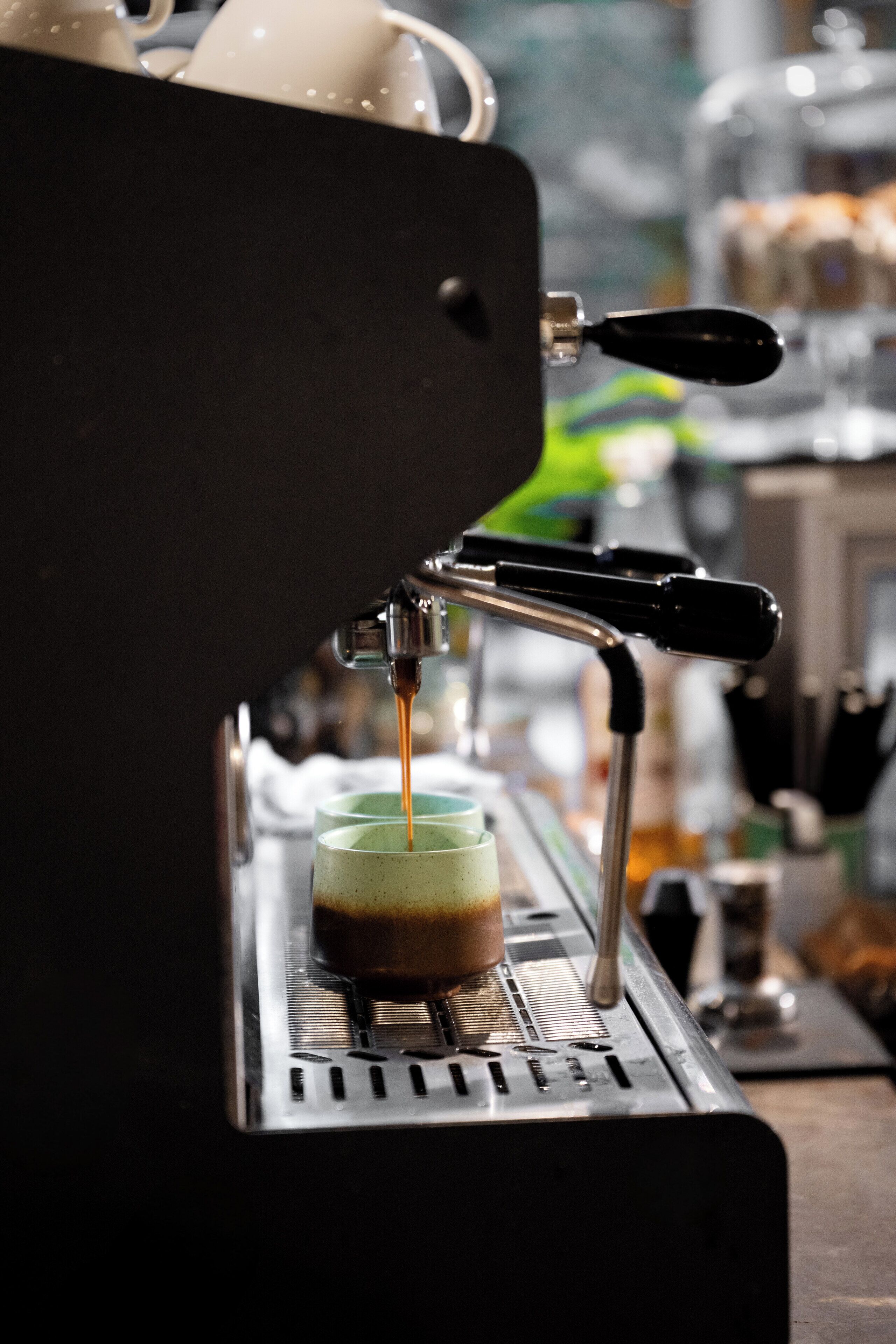 A coffee machine dispensing coffee into a cup.
