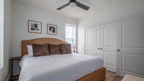 A bedroom with a bed, a ceiling fan, a window, and a wardrobe. - Beautiful Main Street Living in Trussville  (Trussville)
