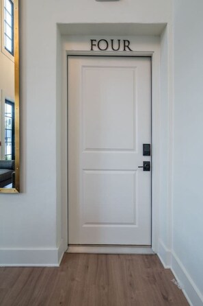 A white door with the word 'FOUR' above it, indicating a room number. - Beautiful Main Street Living in Trussville  (Trussville)