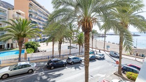 A coastal hotel with a pool, palm trees, and a view of the beach and sea. - Apartment Navio by Interhome (Aguadulce)