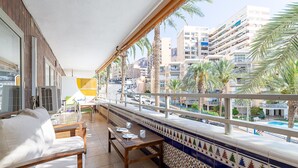 A balcony with a view of a cityscape, including palm trees and multi-story buildings. - Apartment Navio by Interhome (Aguadulce)