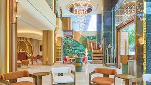 A spacious lobby with a central staircase, seating areas, and a chandelier. - Kin Hotel Thi Sach (Ho Chi Minh City)