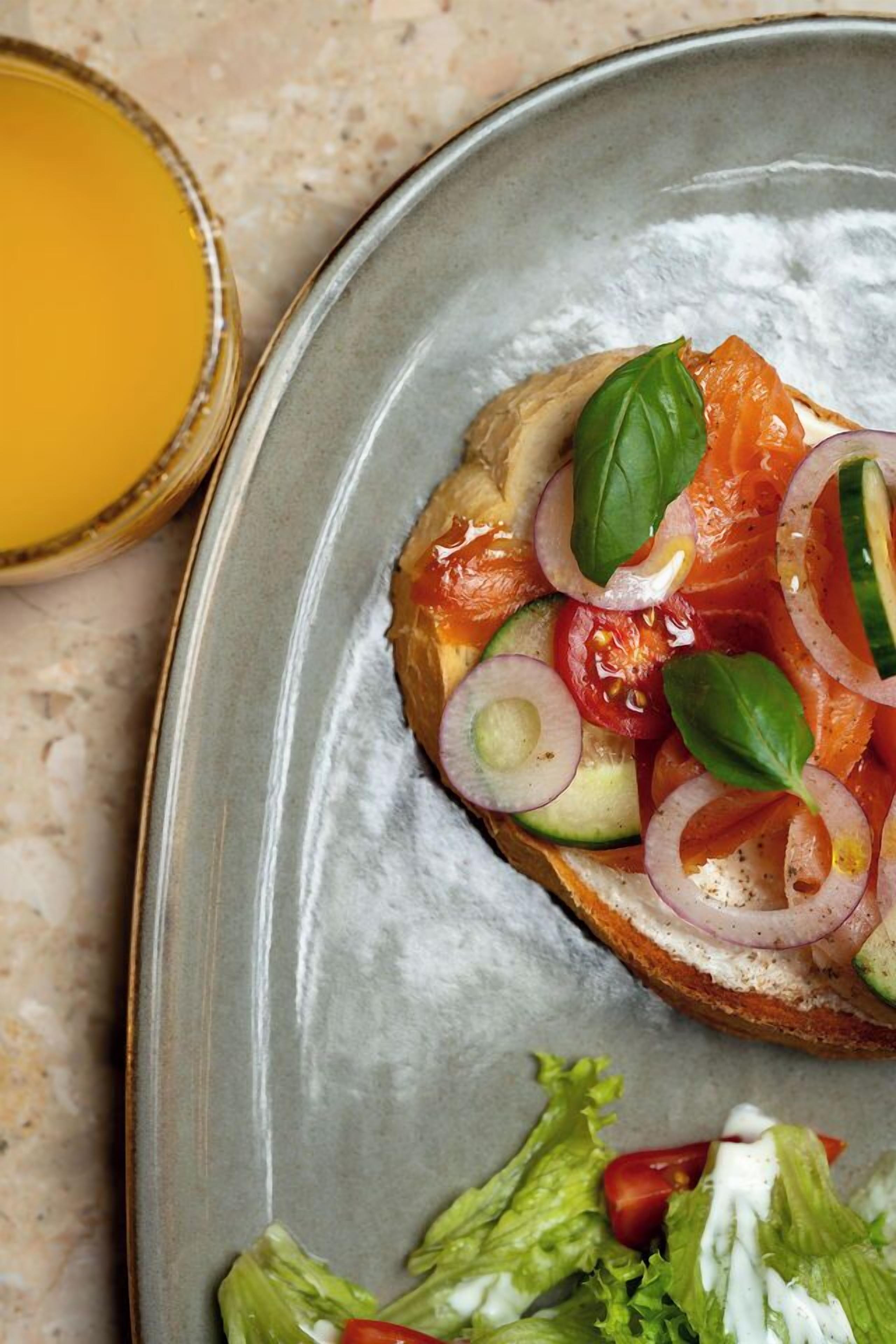 A sandwich with various toppings on a plate.