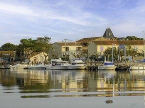 A marina with several boats docked, a building with a tiled roof, and a sign indicating 'Acta Nautica Ville de Fleury'. - Les Terrasses de la Méditerranée by Interhome (Saint Pierre La Mer)