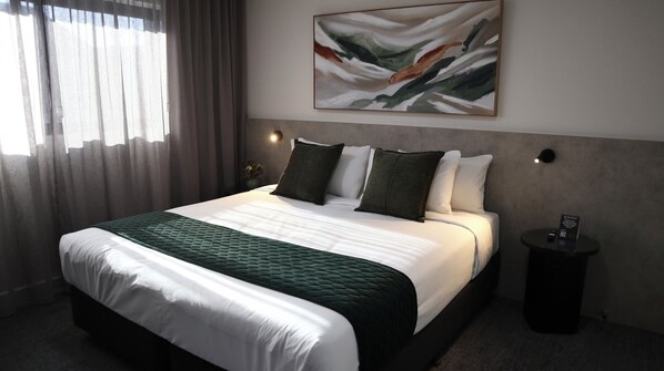 Premium bedding, pillow-top beds, desk, laptop workspace