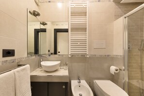 A modern bathroom with a large mirror, a sink, a bidet, and a shower. - 3BR Sorrento Apt with SeaView Terrace (Sorrento)