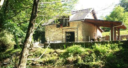 Twelfth-century mill in a green setting.
