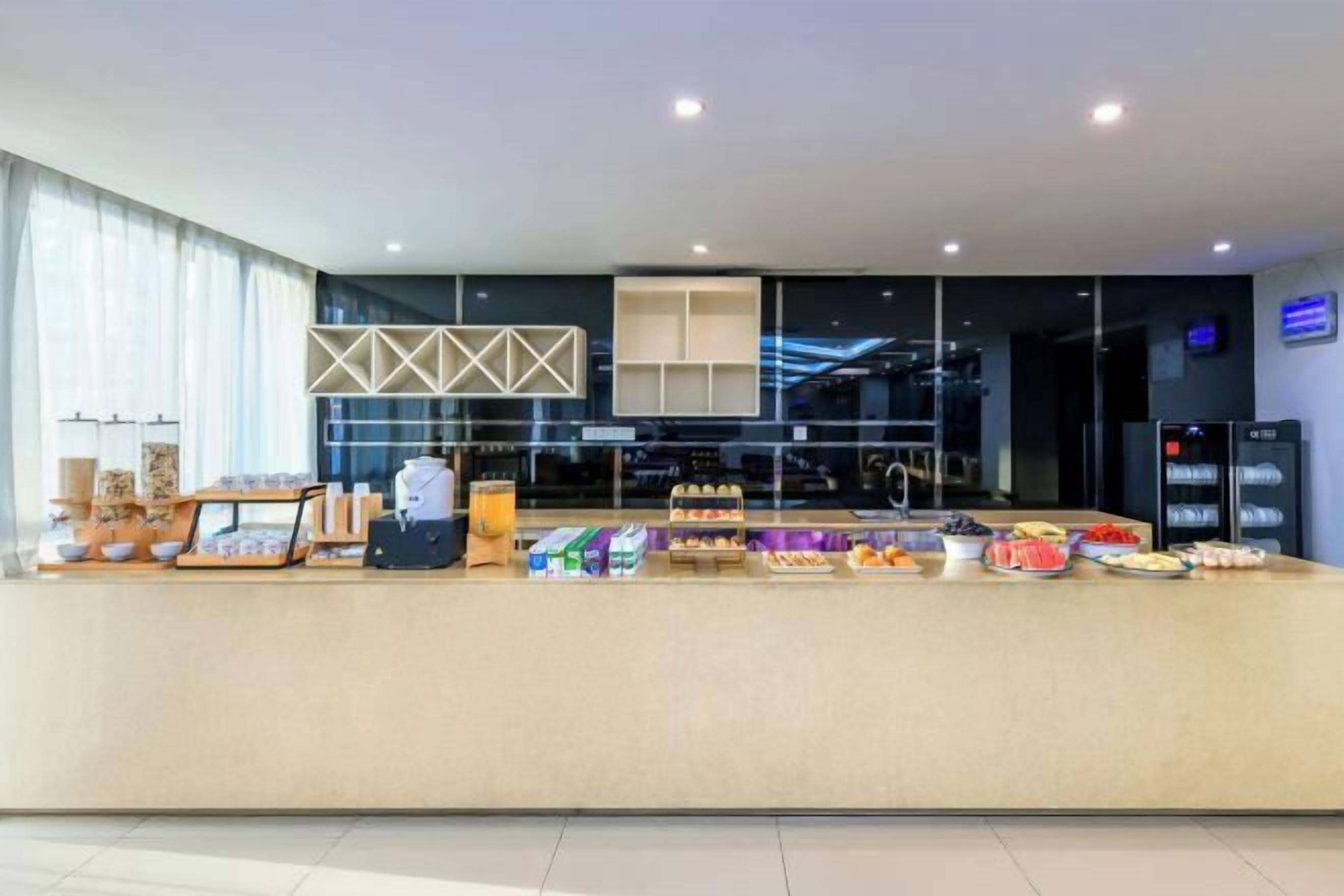 A modern breakfast bar with a variety of food items and a coffee station.