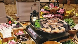 A hot pot setup with various meats, seafood, and vegetables. - Lavande Hotel (Chongqing Guanyinqiao Pedestrian Street) (Chongqing)