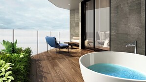 A modern bathroom with a freestanding bathtub, a glass shower enclosure, and a view of the sea. - Birkin International Hotel (Malacca City)