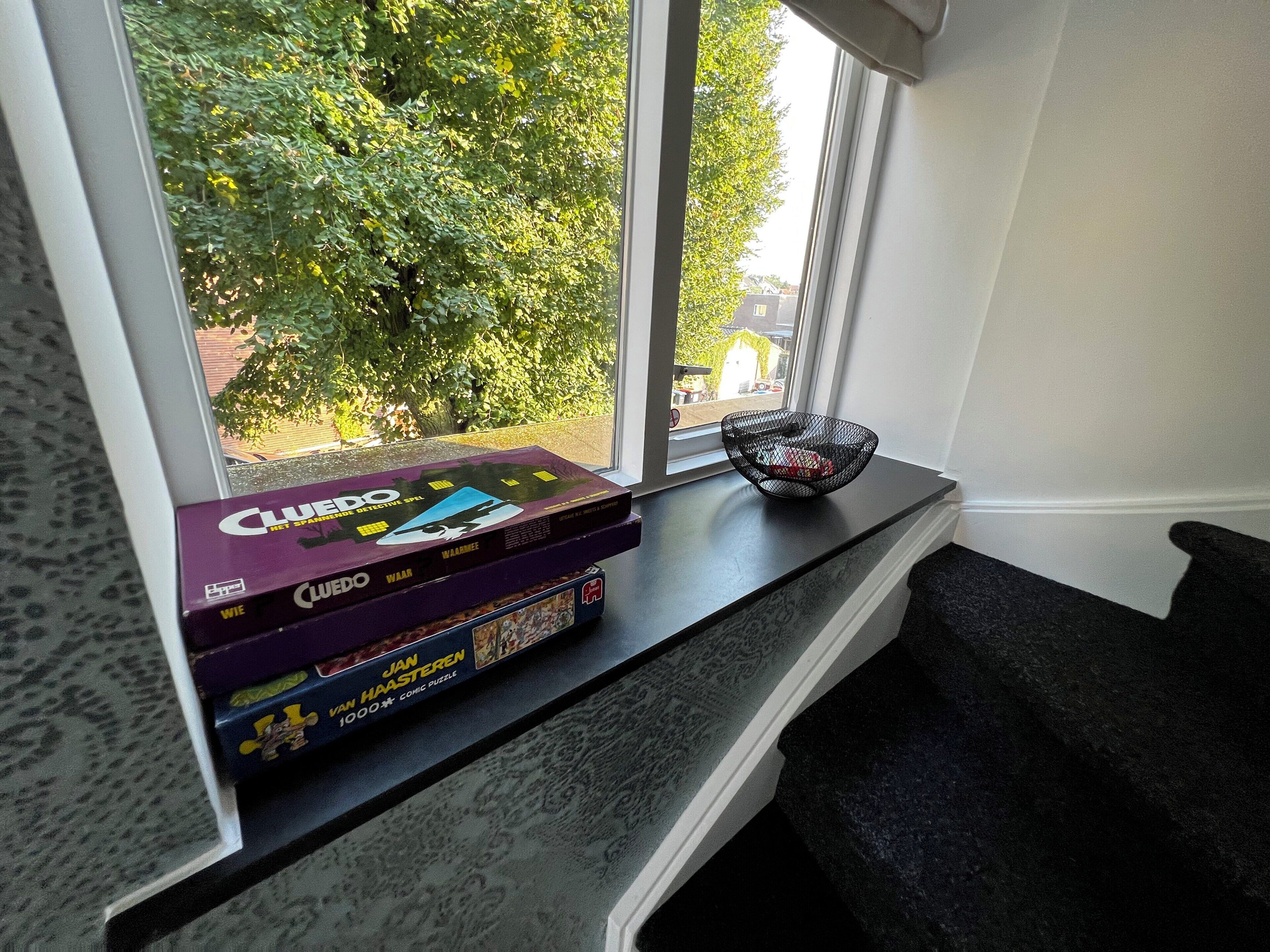 A window seat with a view of greenery outside.