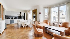 A modern apartment with a kitchen, dining area, and living room.