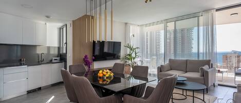 Deluxe Apartment, Sea View | Living room | Flat-screen TV