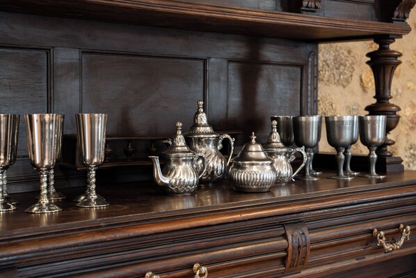 A wooden dresser with silver tea sets and cups. - Pazo Moreda (Sober)