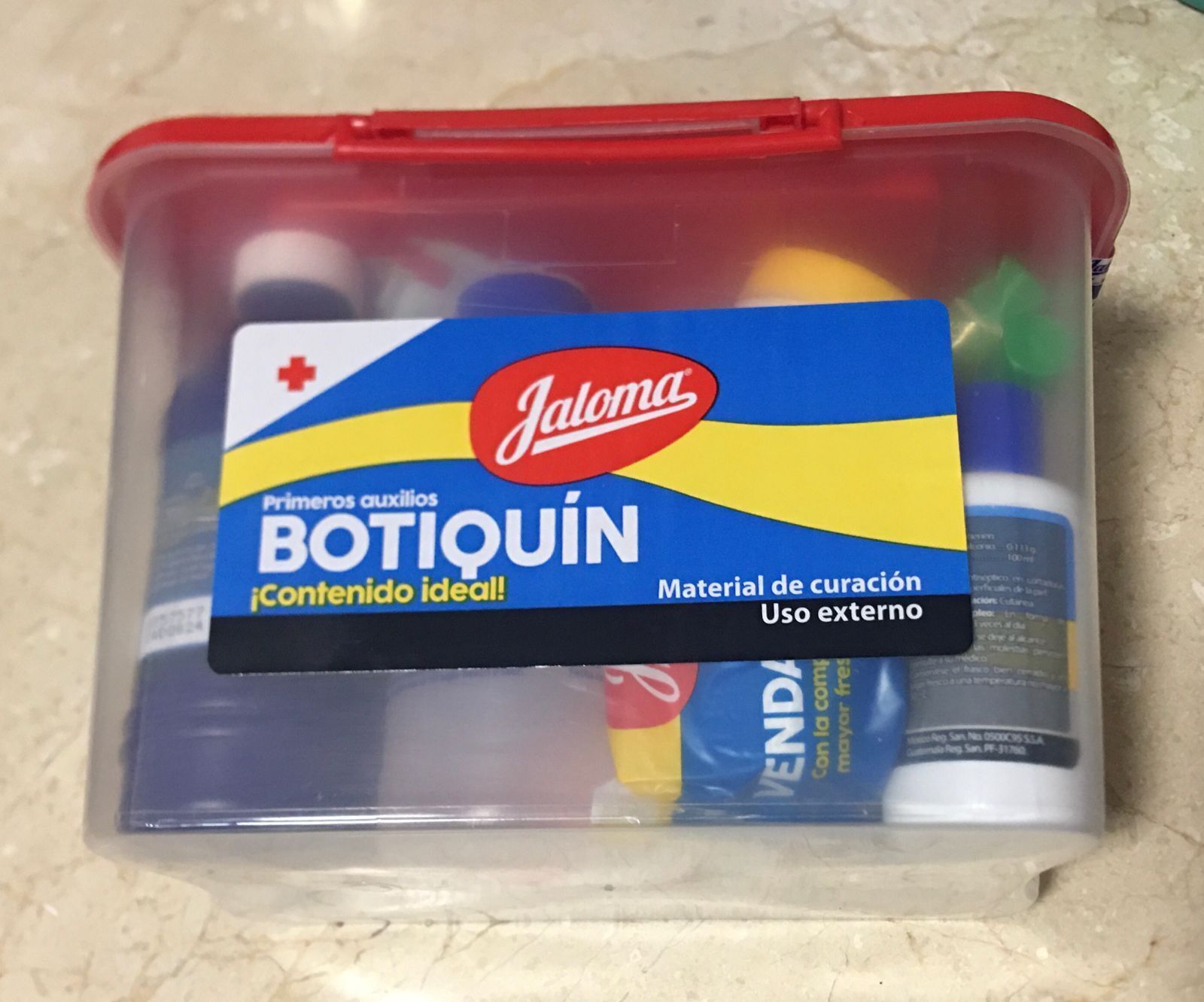 A plastic container with a label for 'Botiquín' medical supplies, including items for external use.