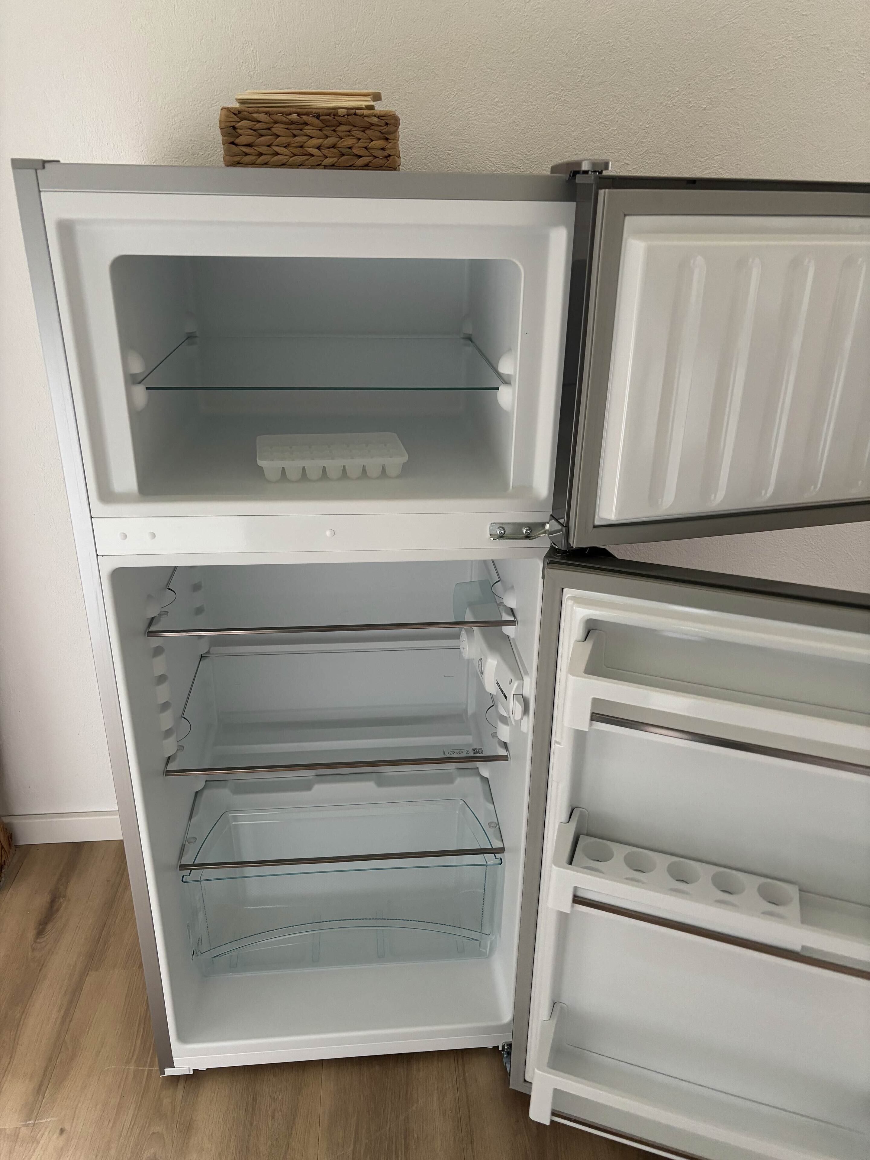 A white refrigerator with two shelves and a freezer compartment.