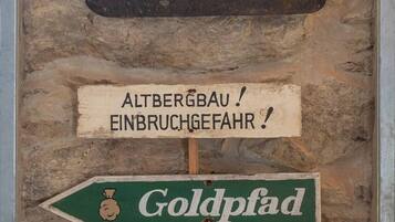 A display of old mining tools and directional signs.