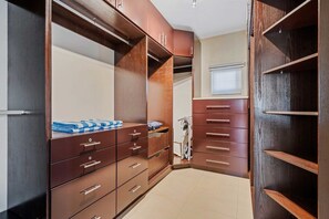A walk-in closet with multiple drawers and shelves, a ladder, and a window with blinds. - Private Pool Oasis! Secluded 4BR w Patio & Parking (Santa Cruz)