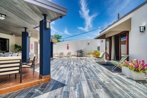 A covered outdoor area with seating and a patio.