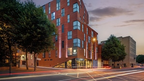 A modern hotel with a prominent corner entrance, multiple windows, and a visible sign for the hotel. - Point A Dublin The Liberties (Dublin)