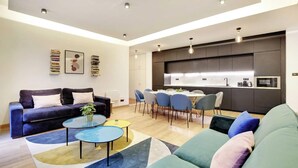 A modern living room with a sofa, coffee table, and dining area. - WHERE EVERY CORNER REVEALS A PIECE OF RICH HISTORY & VIBRANT CULTURE - LE MARAIS (Paris)