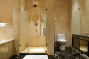A modern bathroom with a glass-enclosed shower, a toilet, and a vanity with a mirror. - New Kwangsi Style Hotel (Guilin)