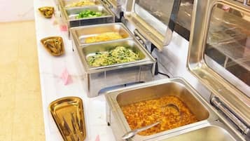 A buffet with various food options in metal containers.