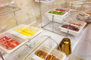 A buffet with various food items in clear containers. - New Kwangsi Style Hotel (Guilin)