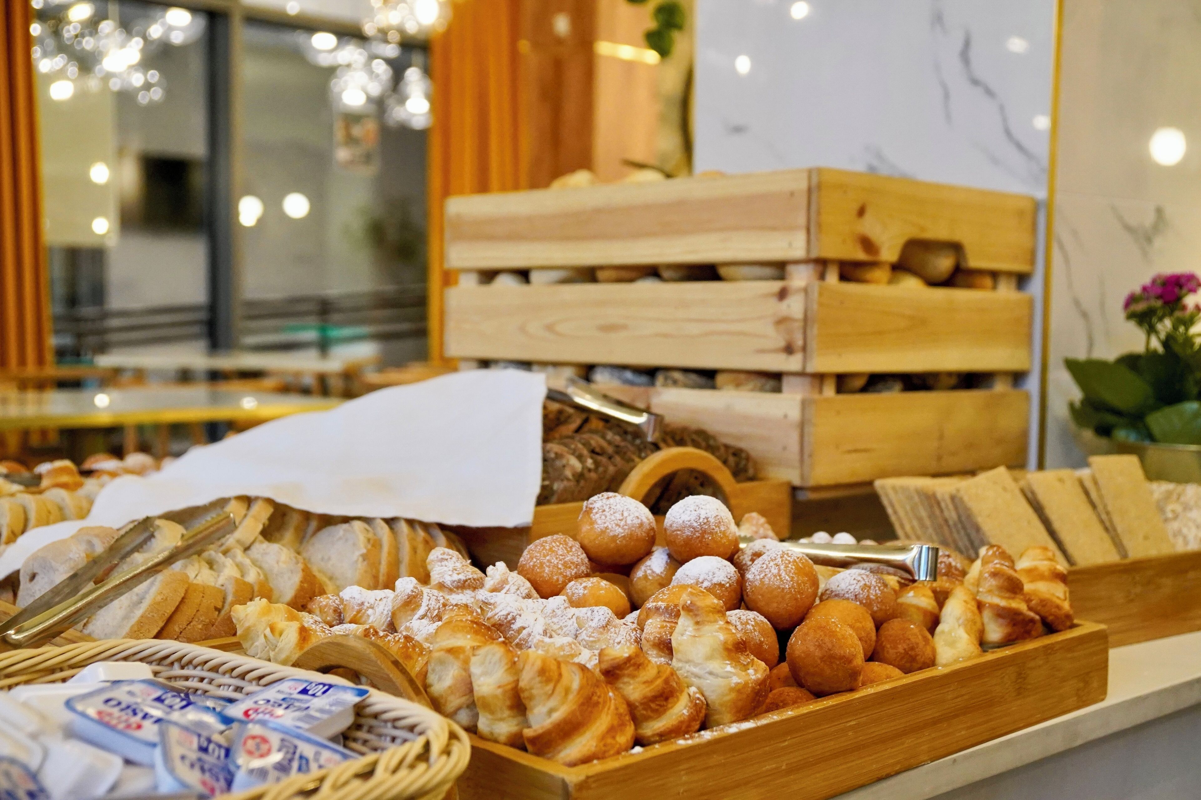 A bakery display with various pastries and bread.