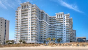 A multi-story hotel with balconies, located near a beach. - Pelican's Perch @ Seawatch (Myrtle Beach)