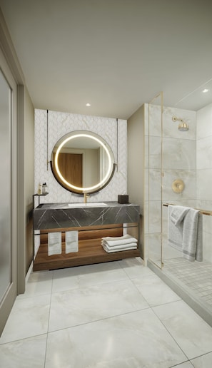 Enjoy a refreshing shower in the bathroom, featuring a bathtub, a large mirror, and a shower with a showerhead.