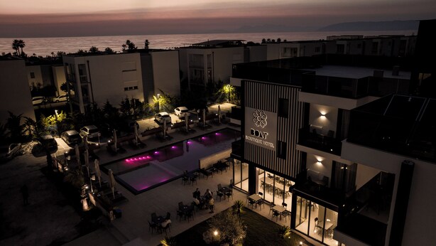 A modern hotel with a rooftop pool, outdoor seating, and a view of the sea. - Bolt Boutique Hotel (Shënkoll)