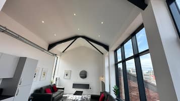 Deluxe Penthouse | Living area | 50-inch TV with cable channels