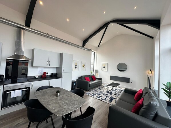 Deluxe Penthouse | Living area | 50-inch TV with cable channels